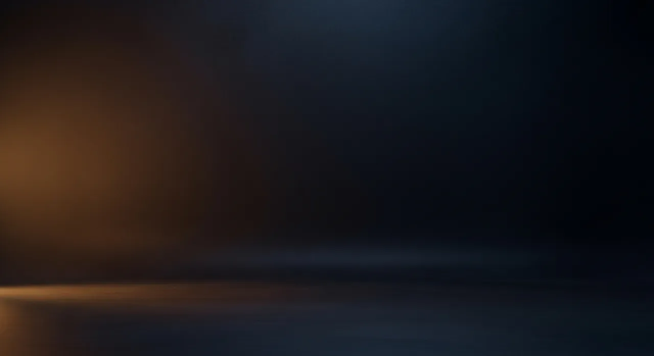 Abstract dark studio backdrop with soft amber light